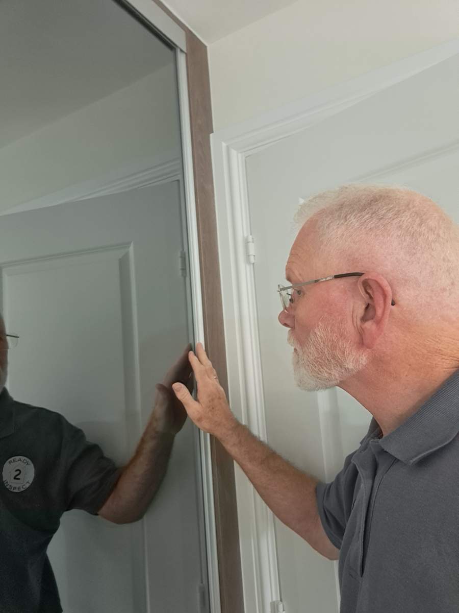 Essential Guide to Professional Home Inspection: Safeguarding Your Dream Home 1 Rob from Ready 2 Inspect inspecting a property as part of a snagging survey inspection